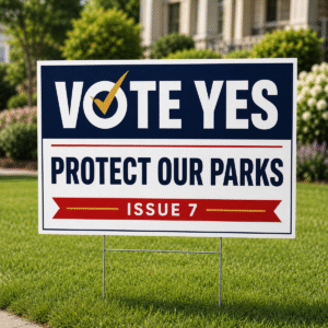 24 × 36 corrugated plastic Vote Yes campaign sign displayed on a landscaped residential lawn