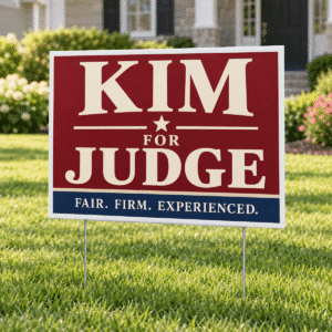 Kim for Judge poly-coated fold-over yard sign displayed on a lawn with a U-shaped wire holder